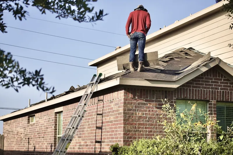 Professional roofer working on a residential roof in Montevideo